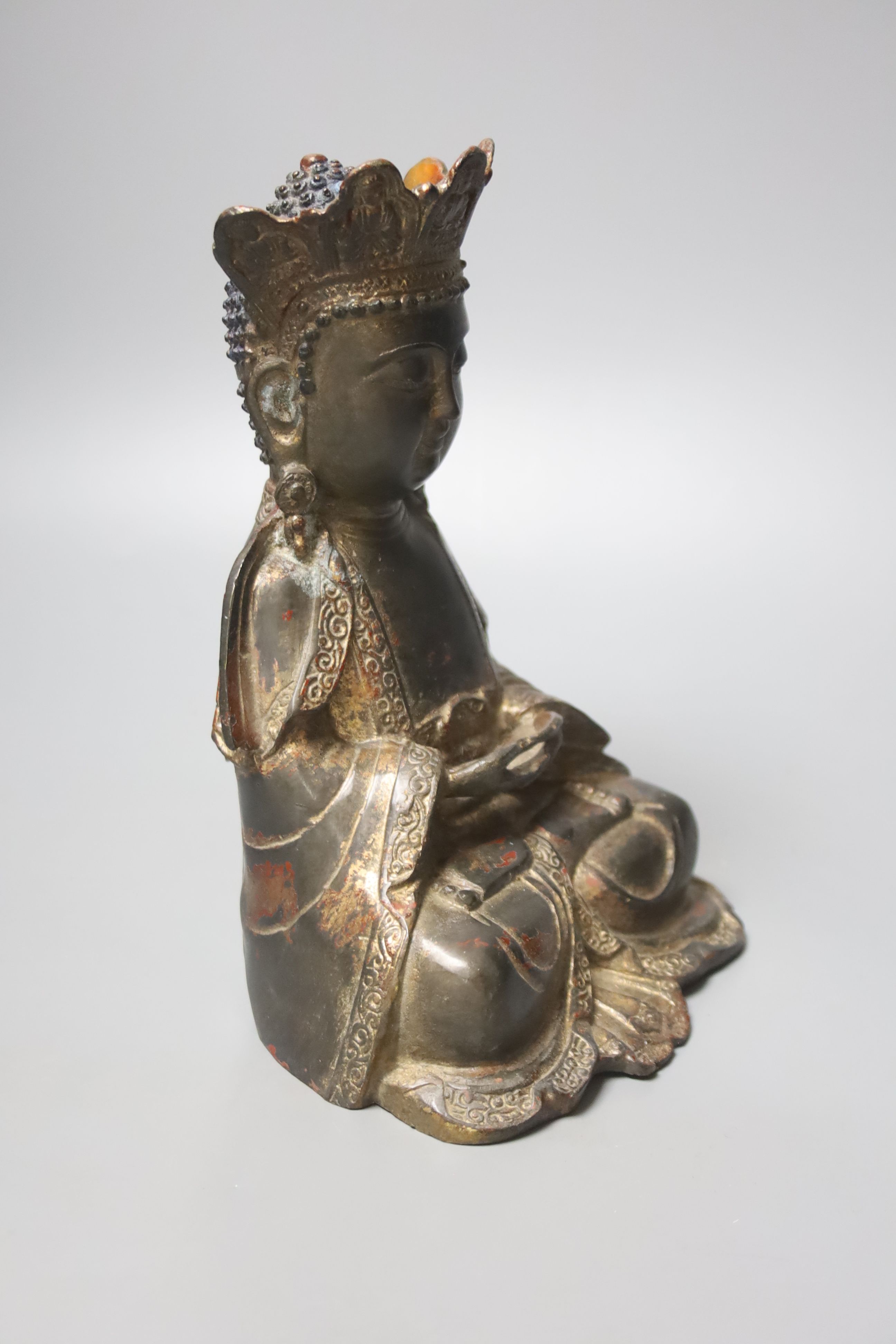 A Chinese gilt lacquered bronze figure of a seated and crowned Buddha, Ming dynasty or later, 21cm high